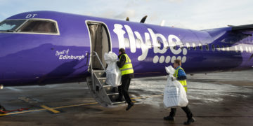 putting packages onto plane photography