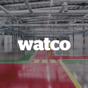 Watco logo overlayed onto a empty warehouse