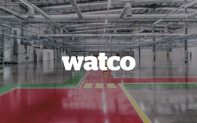 Watco logo overlayed onto a empty warehouse