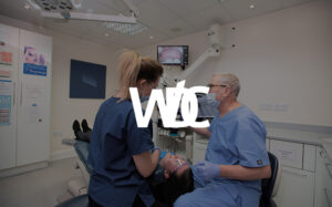 Weybridge Dental care logo overlayed on dentists working on a patient